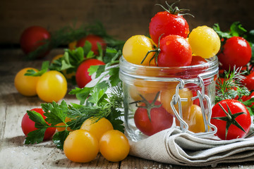 Yellow and red tomatoes in a glass jar, selective focus