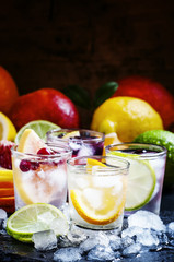 Chilled soft drinks with ice, citrus fruits and berries, black b