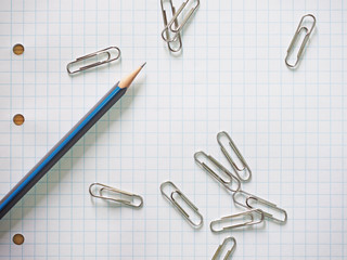 Pencils put on graph paper with wood background