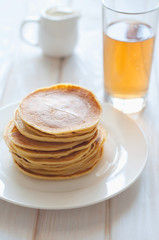 Light breakfast. Fresh pancakes on white plate  in morning light