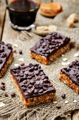 Fototapeta na wymiar raw vegan dates oats peanut butter bars with chocolate frosting