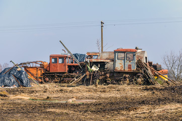 Old rusty broken and abandoned crawler tractors