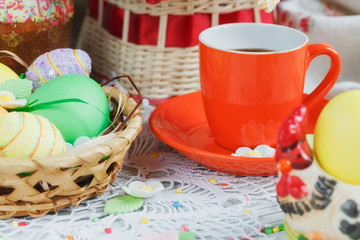 Table setting for Easter - Easter cakes, coffee cup and colored