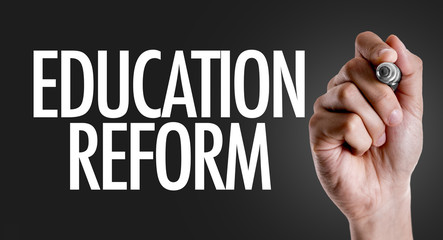 Hand writing the text: Education Reform