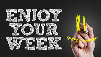 Hand writing the text: Enjoy Your Week