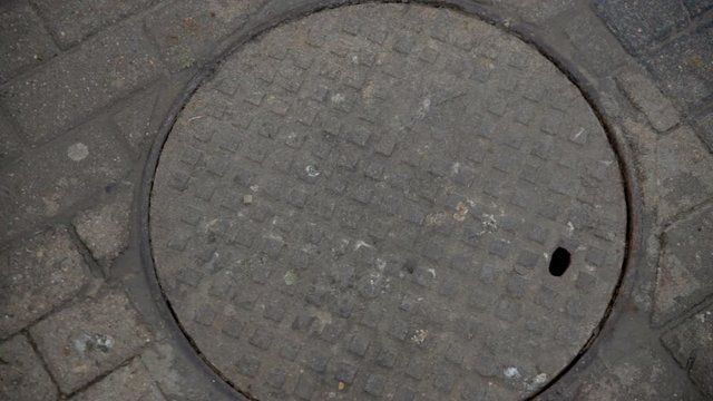 manhole smokes on the street.