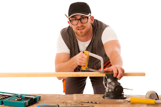 Young carpenter cuts a wooden lath with a saw isolated over whit