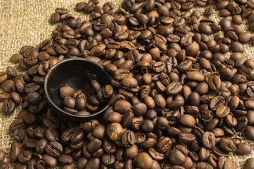 spoon and coffee beans, on the texture of the bag from the fibers