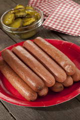 picnic hotdogs and pickles on table