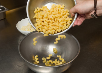 cooked Macaroni pasta being transferred to a meal bowl