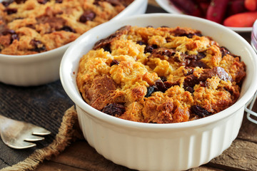 Bread pudding in a white ramekin close up