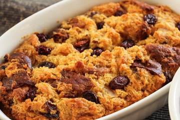 Bread pudding in a white ramekin close up