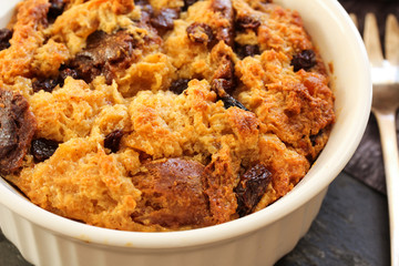 Bread pudding in a white ramekin close up