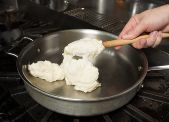 Preparing solid cheese in a pan, for Macaroni cheese