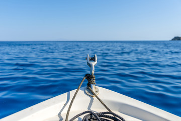 Boat sailing on the deep blue aegean sea. Close-up shot.