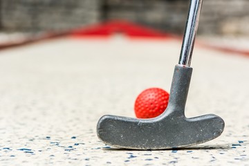 Closeup of red mini golf ball.