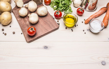 cooking vegetarian food, fresh mushrooms, carrots and parsley oil potatoes border ,place for text  on wooden rustic background top view