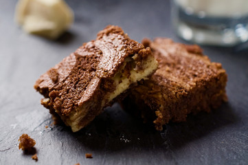 Marble cake brownies on top of each other with milk and white ch