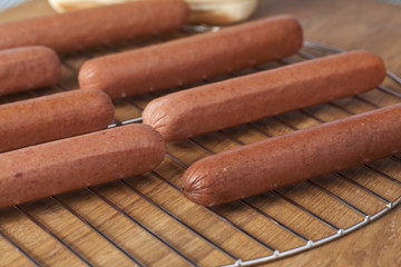 raw hotdogs on grill