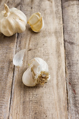 garlic on vintage wood table background - rustic style