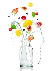 GLASS JAR WITH FRESH FRUITS AND SPLASHING WATER