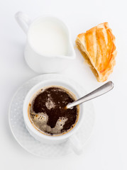 cup of coffee and milk with fresh stuffed pasta