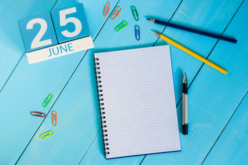 June 25th. Image of june 25 wooden color calendar on blue background. Summer day. Empty space for text