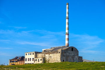Fototapeta na wymiar Old factory building in Piraeus, Athens. Clear blue sky in the b