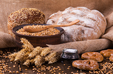 Assortment of baked bread on wooden table background