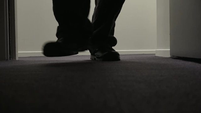 Man walks into apartment from a corridor at night.Mystery, spooky, creepy and dramatic drama concept