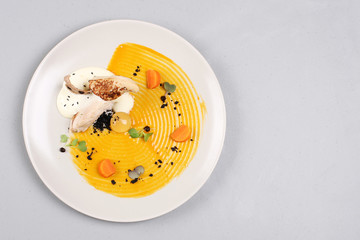 chicken breast with vegetables on a white plate.