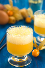 Peruvian cocktail called Aguaymanto Sour (Physalis Sour) prepared from physalis juice, pisco (Peruvian grape hard liquor), syrup and egg white (Selective Focus, Focus in the middle of the froth)