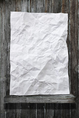Crumpled white paper on wood shelf