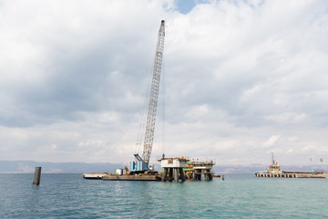 Aqaba, Jordan, 10/10/2015, A crane working on the support foundation construction at the Aqaba new port