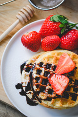 healthy breakfast waffle with strawberry  and chocolate syrup on
