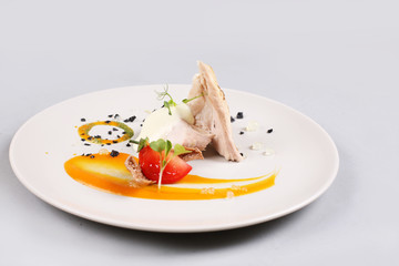 chicken breast with vegetables on a white plate.