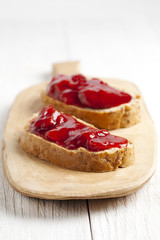 two slices of strawberry jam sandwich