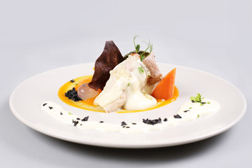 chicken breast with vegetables on a white plate.