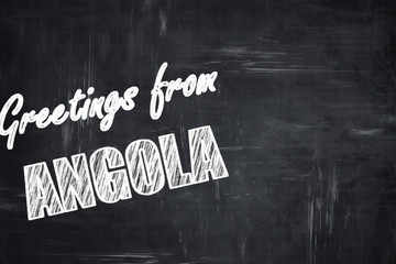 Chalkboard background with chalk letters: Greetings from angola