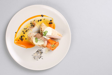 chicken breast with vegetables on a white plate.