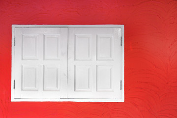 White wooden window on red wall