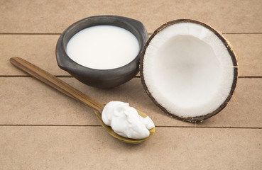 Oil and coconut cream on wooden background