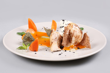 chicken breast with vegetables on a white plate.