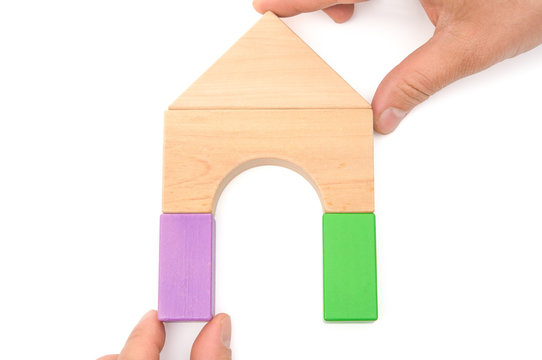 hands making up a house on white with clipping path