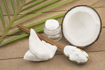 Oil and coconut cream on wooden background