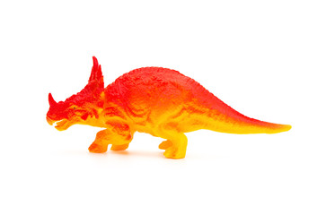 side view orange triceratops toy on a white background