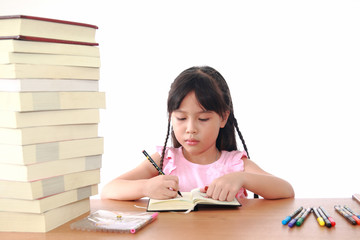 Asian little girl draw on a book isolated on a over white backgr