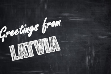 Chalkboard background with chalk letters: Greetings from latvia