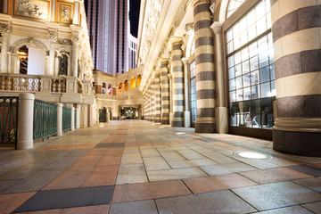 empty marble footpath and modern buildings at night in city
