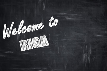 Chalkboard background with chalk letters: Welcome to riga